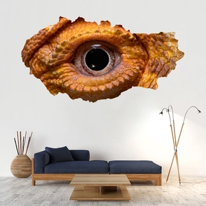 Detailed view of 3D broken wall reptile eye sticker over a sofa in a modern living room