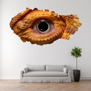 Detail of 3D wall sticker featuring a realistic orange reptile eye in a torn hole design