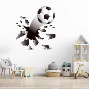 Detail showing 3D football wall decal breaking through a realistic gray brick wall effect
