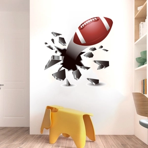 3D football wall decal showing an American rugby ball breaking through the white room wall
