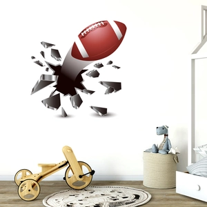 Detailed 3D wall sticker showing a realistic American football breaking through a grey wall