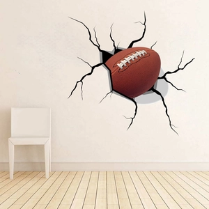 Macro detail of 3D cracked wall decal featuring a realistic textured American football sticker