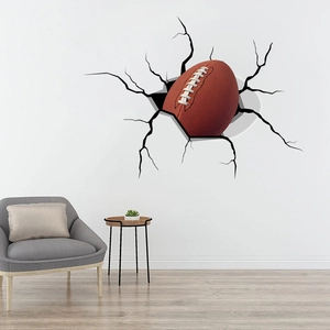 3D broken wall crack effect vinyl sticker featuring an American football for home decor