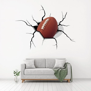 3D vinyl wall decal showing an American football breaking through a cracked wall decor