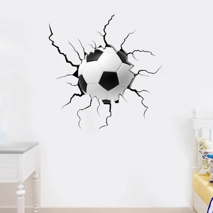 Detail showing 3D football wall decal with realistic cracked wall effect in a bedroom