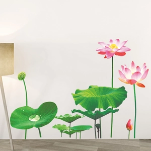 Detailed view of pink lotus flower wall decals with green leaves and a warm floor lamp