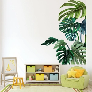 Detail of tropical Monstera leaf wall stickers in a bright, modern nursery playroom