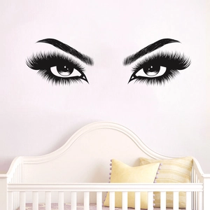 Detailed view of black vinyl eye lash wall decal on a white bedroom wall