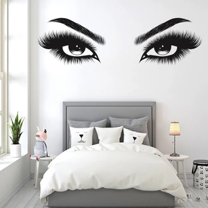Detailed close-up of vinyl eye lashes wall decal sticker in a modern bedroom setting