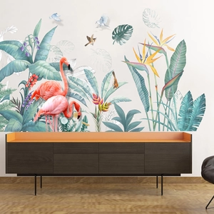 Detail of self-adhesive wall sticker with pink flamingos and tropical monstera leaves