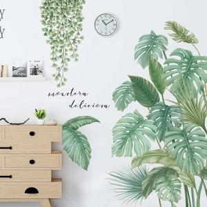 Detail of realistic monstera leaf wall stickers with handwritten style name labels