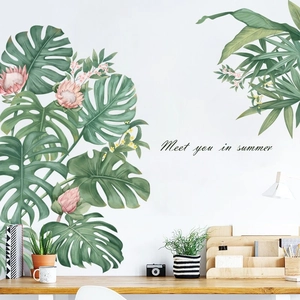 Detail view of tropical monstera leaves and king protea flower wall decals in a cozy room