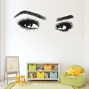 Detail of minimalist black eyelash wall decal in a sunlit bedroom setting decoration