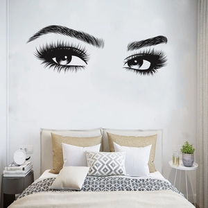 Detail view of black vinyl eye lash wall stickers on a modern bedroom wall decor