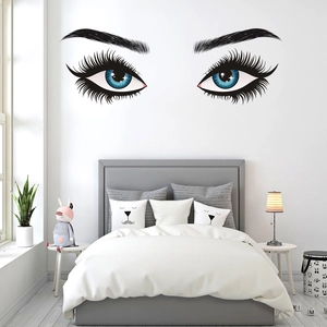 Detailed view of beautiful eyelashes wall sticker above bed in bedroom decor