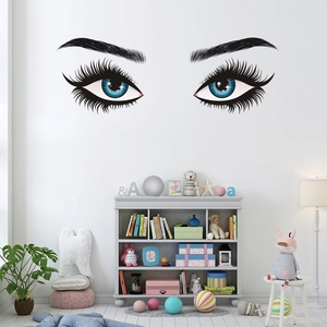 Artistic eye lashes wall decal display in a modern minimalist bedroom setting