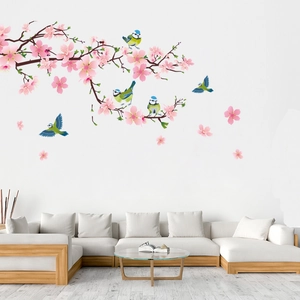 Detail of pink cherry blossom and bird wall decals applied to a modern living room wall
