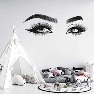 Detail view of black vinyl wall sticker showing elegant long eyelashes and eyebrows design
