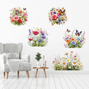 Floral wall stickers featuring grass and butterfly patterns on a white wall in a living room
