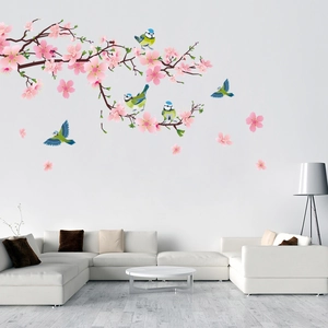 Detailed wall sticker featuring pink cherry blossom branches and blue tit birds on a white wall