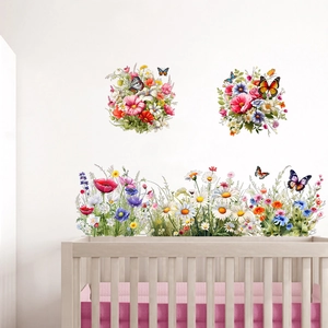 Detail of floral and butterfly wall decals applied on a clean white nursery wall surface