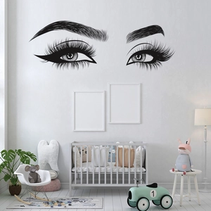 Detailed view of black vinyl eye lash wall stickers in a cozy nursery room setting