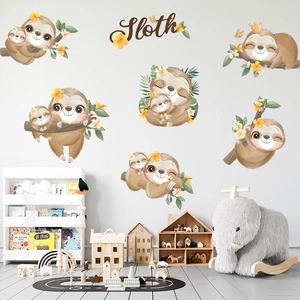 Detail of sloth wall stickers on a nursery wall with leaves and yellow flowers