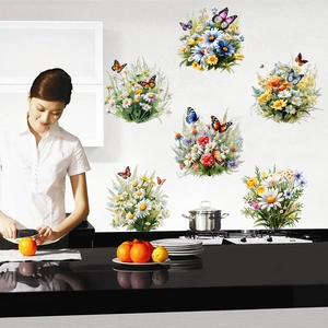 Close-up of botanical wildflower and butterfly wall stickers in a modern kitchen setting