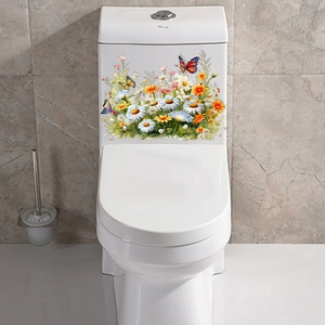 Stickers muraux fleurs et papillons sur un réservoir de toilettes en céramique blanche