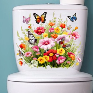 Détail de stickers de fleurs et papillons colorés sur un réservoir de toilettes blanc