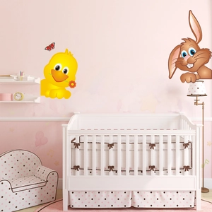Close-up of cute cartoon duck and rabbit wall decals in a cozy pink nursery setting