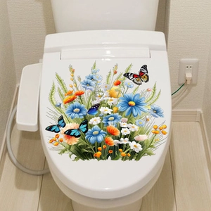 Détail de stickers autocollants fleurs et papillons sur un abattant de WC blanc
