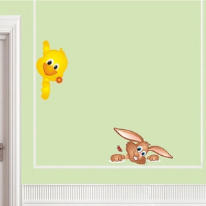 Detail of yellow bird and brown rabbit wall decals on a soft green nursery wall