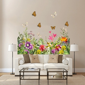 Détail de stickers muraux aux plantes tropicales avec fleurs et papillons colorés