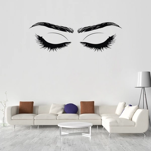 Minimalist long eyelashes and eyebrows wall decal in a modern living room setting