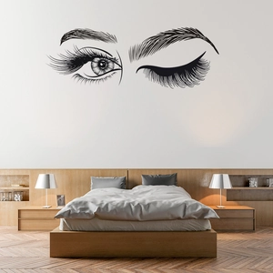 Minimalist wall decal featuring long eyelashes and winking eye design for home decor
