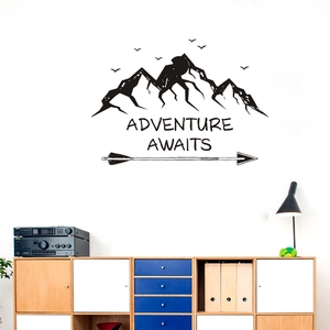 Adventure Awaits wall decal with mountain and arrow design above a modern wooden cabinet