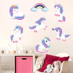 Detail of magical unicorn and rainbow wall decals in a cozy pastel children bedroom