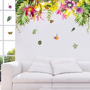 Detail of tropical leaf wall decals with flowers and butterflies in a bright living room