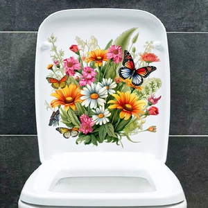 Détail des autocollants de fleurs et papillons colorés sur un couvercle de toilette blanc