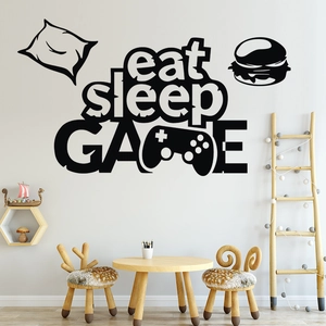 Detail of matte black Eat Sleep Game wall decal in a cozy children playroom setting