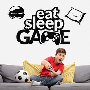 Detail of eat sleep GAME vinyl wall decal with controller icon on a white bedroom wall