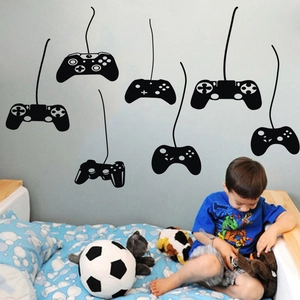 Detail view of 7 black game controller silhouette wall stickers in a bedroom interior