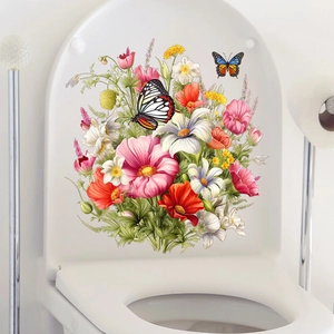 Détail de stickers autocollants fleurs et papillons colorés sur un abattant de WC blanc