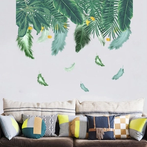 Detailed wall sticker layout featuring tropical palm leaves and feathers on white wall