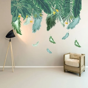 Detail of tropical palm leaves and gradient feathers wall stickers in a modern living room