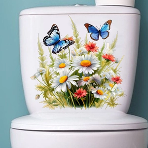 Détail de stickers étanches papillon et marguerite sur le réservoir de la toilette