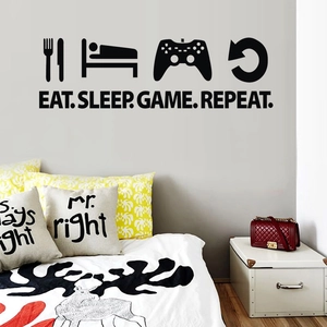 Macro detail of Eat Sleep Game Repeat wall decal on a modern bedroom background