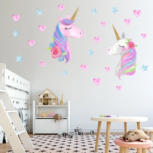 Detailed view of unicorn and star wall stickers in a cozy children bedroom setting