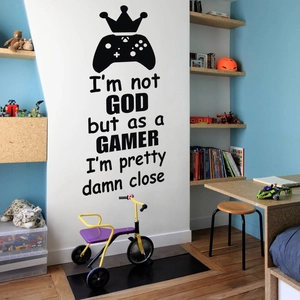 Detail shot of black game controller wall decal with crown and gamer slogan in a child room